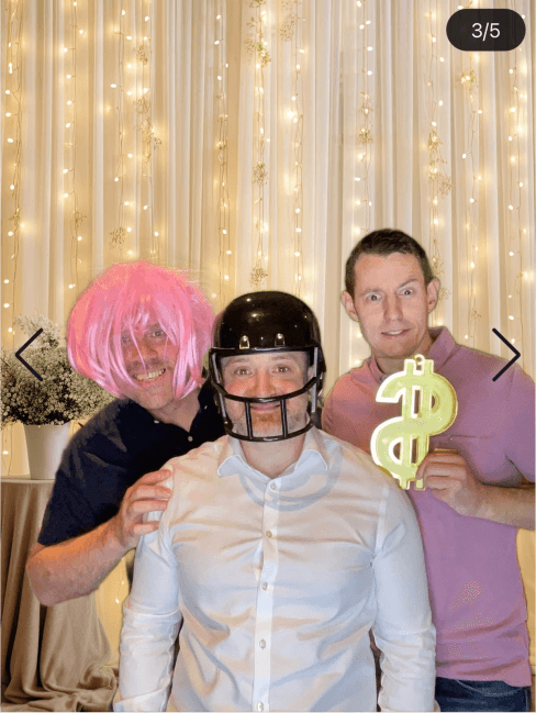 Party guests having fun with photo booth props