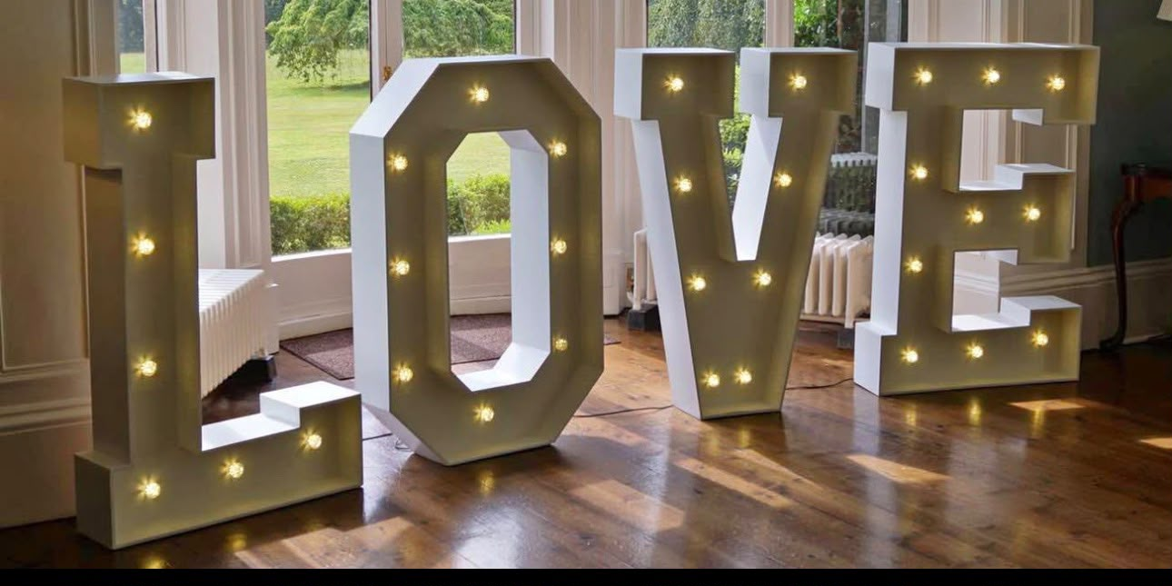 Illuminated LOVE letters at a wedding