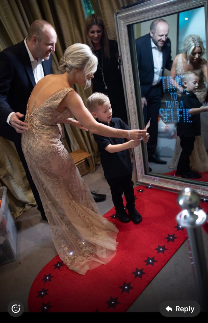 Family using the magic mirror photobooth at a wedding reception