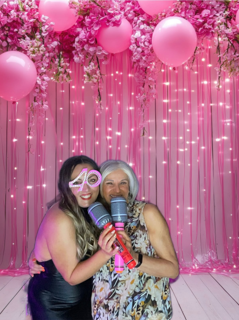 Guests enjoying the photo booth at a 40th birthday party
